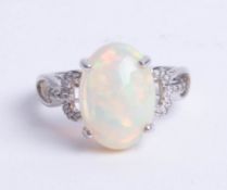 An 14ct opal and diamond ring, size N.