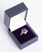 An 18ct rose gold umbalite garnet and diamond cluster ring set with further diamonds to the