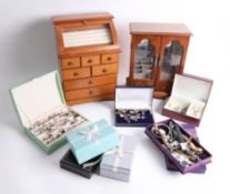 A large collection of costume jewellery and two table cabinets.