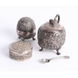 An Indian white metal pepper pot, sugar pot, and trinket box. (3)