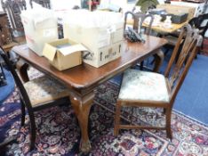 A mahogany dining table with four chairs, also another chair, height 135cm.