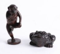 Two Japanese dark wood netsukes, one depicting a toad and the other depicting a monkey on one leg.