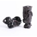 Two Japanese dark wood netsukes, one depicting two frogs and a tree trunk and the other depicting