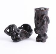 Two Japanese dark wood netsukes, one depicting two frogs and a tree trunk and the other depicting