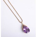 An amethyst and diamond pear drop pendant set in gold on a gold chain marked 14k.