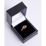 An 18ct diamond and citrine ring, size L.