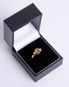 An 18ct diamond and citrine ring, size L.