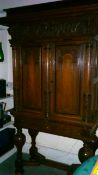 A continental Dutch? carved oak cabinet, on stand, the base with bulbous legs and shaped stretchers,