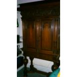 A continental Dutch? carved oak cabinet, on stand, the base with bulbous legs and shaped stretchers,