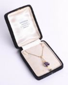 An amethyst and gold pendant on chain with box, in boxed marked 'Markar, Kowloon'.