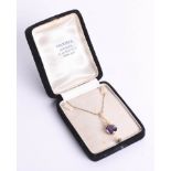 An amethyst and gold pendant on chain with box, in boxed marked 'Markar, Kowloon'.