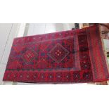 RED AND BLUE GROUND HAND KNOTTED WOOLEN MESHWANI RUNNER WITH FIVE MEDALLIONS (244CM X 63CM)
