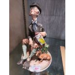 CAPODIMONTE 'O SOLE MIO' FIGURE OF SEATED MAN WITH BOWLER HAT, MUSIC BOX AND DOG, INCISED SIGNATURE