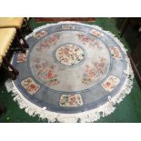 CIRCULAR EMBOSSED WOOLEN BLUE GROUND PATTERNED FLOOR RUG WITH TASSELLED EDGE