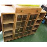 LIGHT OAK BOOKCASE WITH TWO CENTRAL GLAZED DOORS WITH SINGLE DRAWER ABOVE, FLANKED BY FOUR