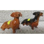 TWO BESWICK DOGS - BROWN SEATED DACHSHUND (HEIGHT 7CM) AND BLACK / BROWN SEATED DACHSHUND (7CM)