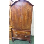 MAHOGANY VENEERED TWO DOOR CUPBOARD WITH TWO DRAWERS BENEATH STANDING ON CABRIOLE LEGS