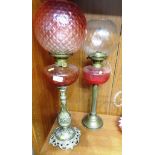 TWO BRASS OIL LAMPS WITH GLASS RESERVOIRS AND SHADES