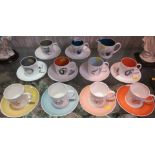 SELECTION OF SUSIE COOPER COFFEE CUPS AND SAUCERS DECORATED WITH FRUIT AND INSTRUMENTS