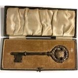 Silver presentation key hallmarked Birmingham 1928 and stamped with maker's mark WHH. The shaped bow