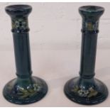 Pair of William Moorcroft Pottery candlesticks modelled in the 18th century style, blue-green,