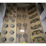 SELECTION OF VINTAGE DRAWER HANDLES, MOUNTED ON WOOD