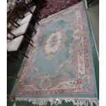 LARGE RECTANGULAR GREEN GROUND EMBOSSED FLORAL PATTERNED RUG WITH TASSELLED ENDS (276CM X 184CM)