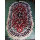 RED GROUND D-END FLORAL PATTERNED RUG WITH FLORAL DESIGN AND TASSELLED EDGE (146CM X 81CM) *