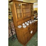 ERCOL MID ELM DRESSER WITH TWO GLAZED DOORS AND ADJUSTABLE SHELVING TO TOP, FOUR DRAWERS OVER