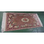 PALE BROWN GROUND EMBOSSED FLORAL PATTERNED RECTANGULAR FLOOR RUG WITH TASSELLED ENDS (174CM X