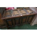 STAINED OAK LIFT TOP BLANKET BOX WITH CARVED PANELS