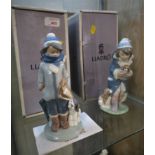 TWO LLADRO FIGURINES WITH BOXES - BOY WITH DOG AND GIRL WITH PUPPIES