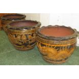 THREE LARGE BROWN GLAZED TERRACCOTA POTS DECORATED WITH DRAGONS