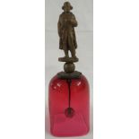 Cranberry glass table bell etched 'Waterloo' with a gilt metal handle modelled as Napoleon, height