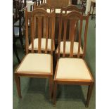 Set of four oak framed Arts and Crafts style dining chairs with shell carving to the top rail, cream