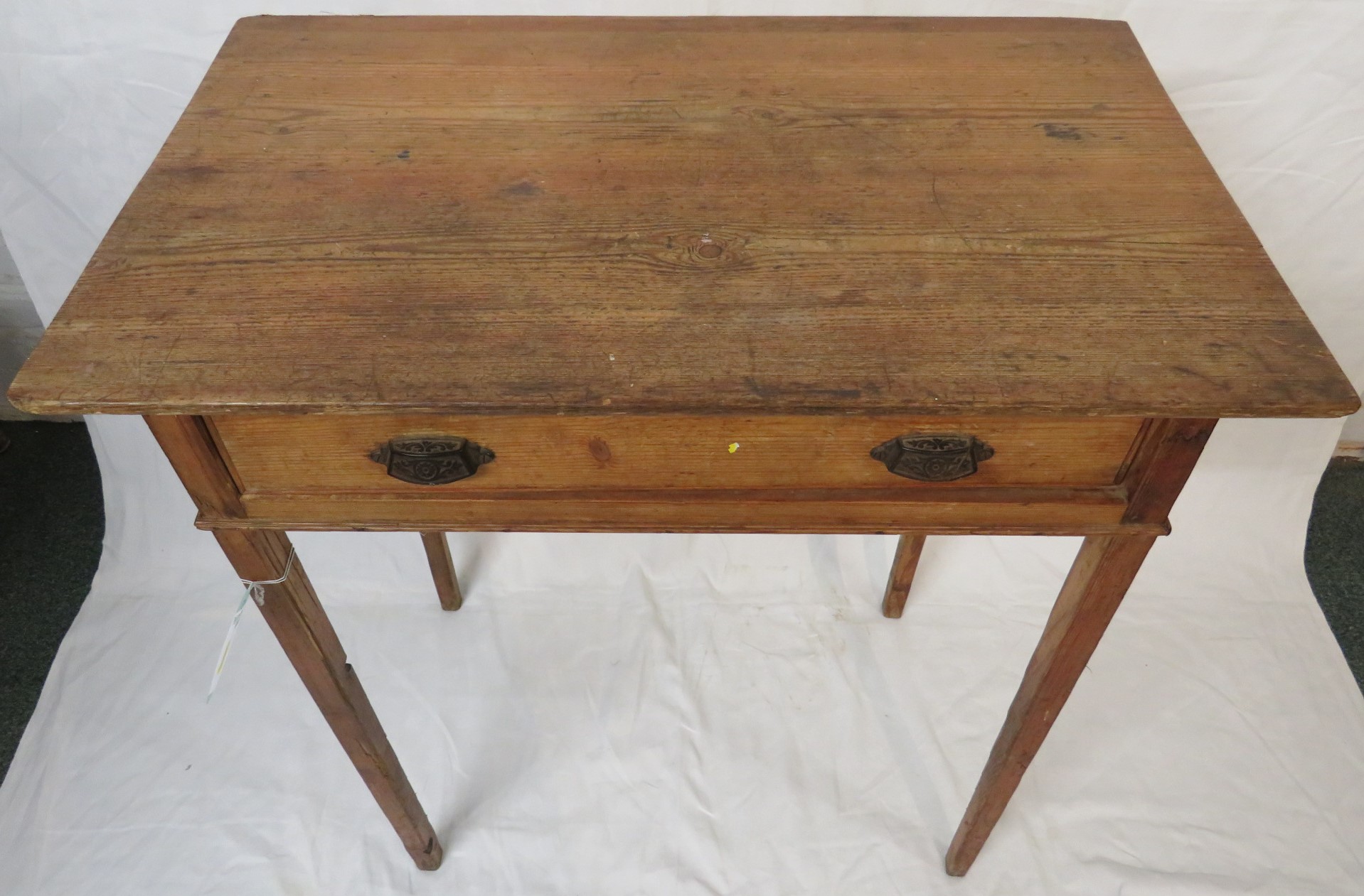 Rustic pine single-drawer side table with embossed metal lug handles, on square tapering legs,