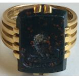 Yellow metal ring set with a rectangular green and red stone intaglio seal, eagle's head and motto