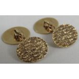 Pair of 9 carat gold oval bark finish cufflinks, combined weight 6.7g