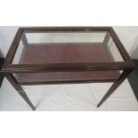 A mahogany display table or bijouterie, with a hinged glazed top, glazing to four sides, the
