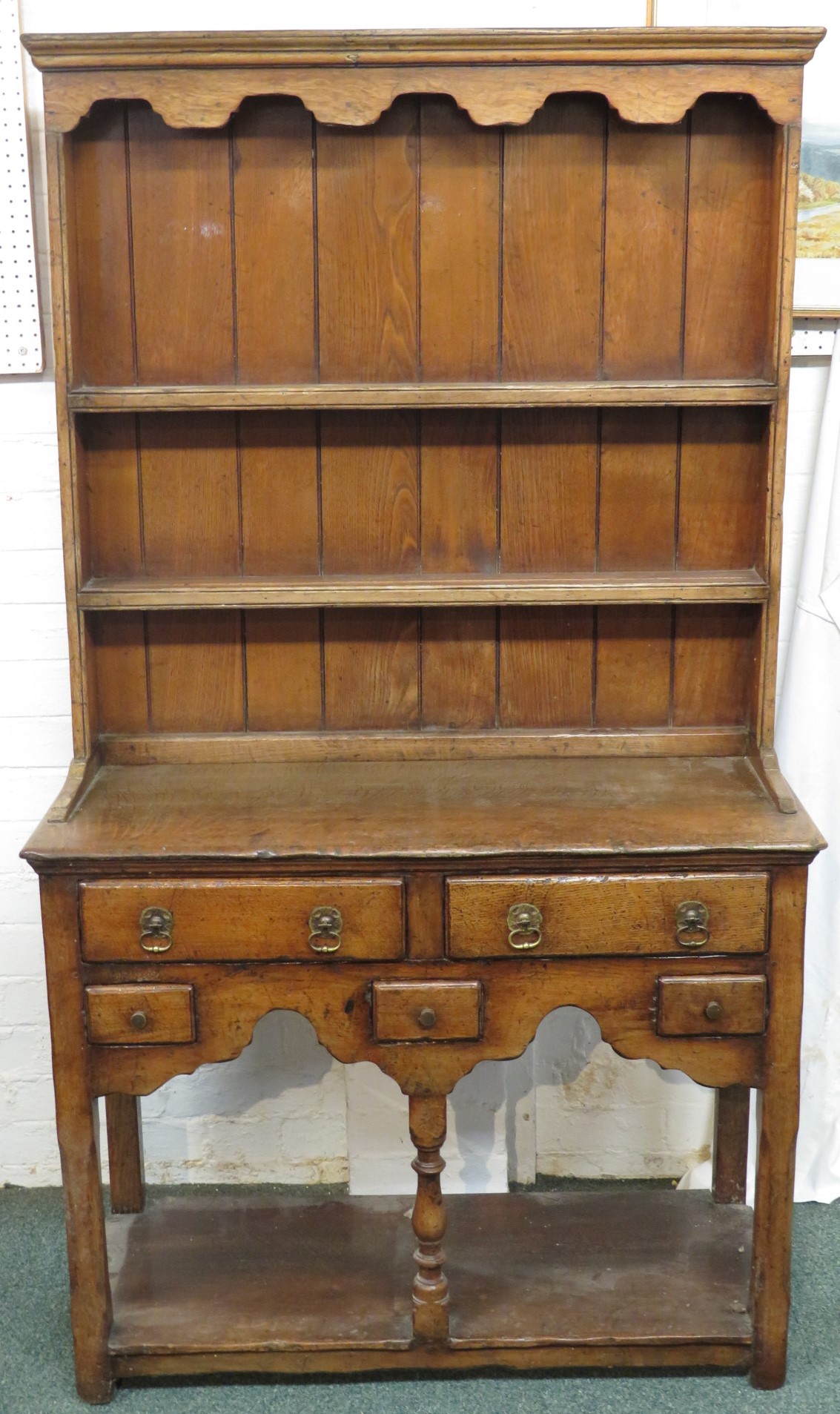 A small oak dresser (height 162cm, width 92cm, depth 37cm), the upper section with wavy