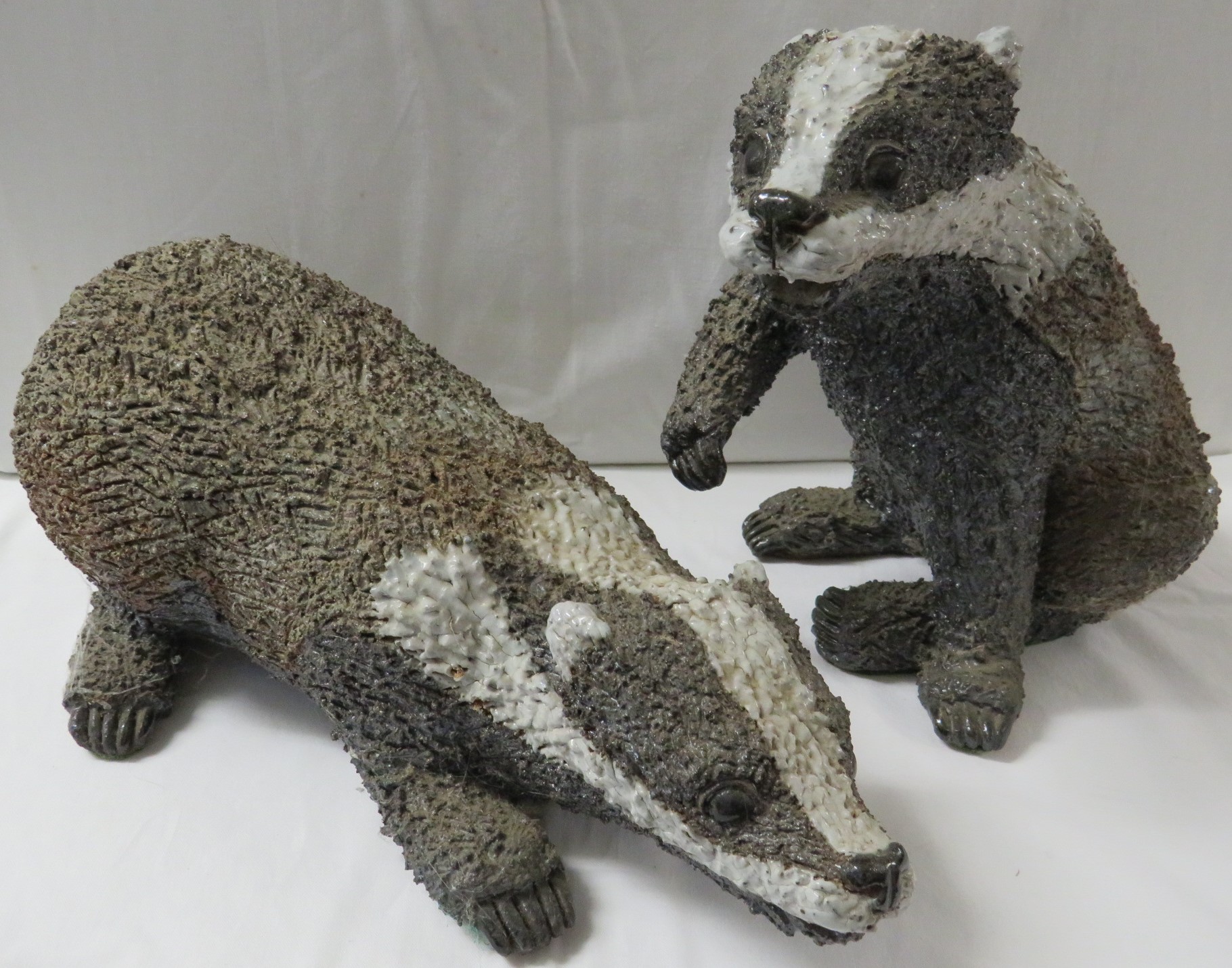 Gil Tregunna studio pottery figure of a crouching badger, signed, length 41cm, together with a