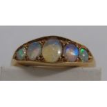 Yellow metal ring set with five graduated opals, the largest 5.5mm x 4mm, worn hallmarks to the