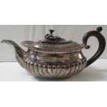 George III silver teapot with half reeded body, foliate moulded knop, and a replacement plastic