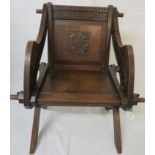 Oak reproduction medieval throne armchair, carved with a long Latin inscription across the arms