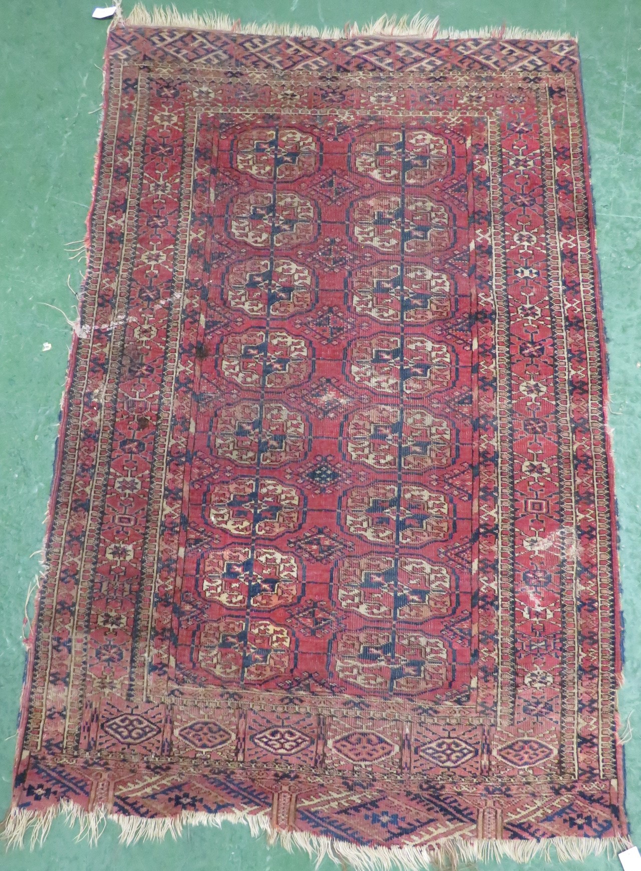 19th century Persian Bokhara pale red ground rug with sixteen medallions, 91cm x 141cm