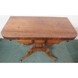 Regency banded mahogany card table, folding top with green baize, on a squared baluster column,