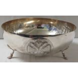 White metal circular fruit bowl raised on three paw feet, with three engraved repousse vignettes