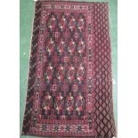 Dark blue and brown ground Yomut rug with sixteen medallions, stylized floral motifs, and a wide