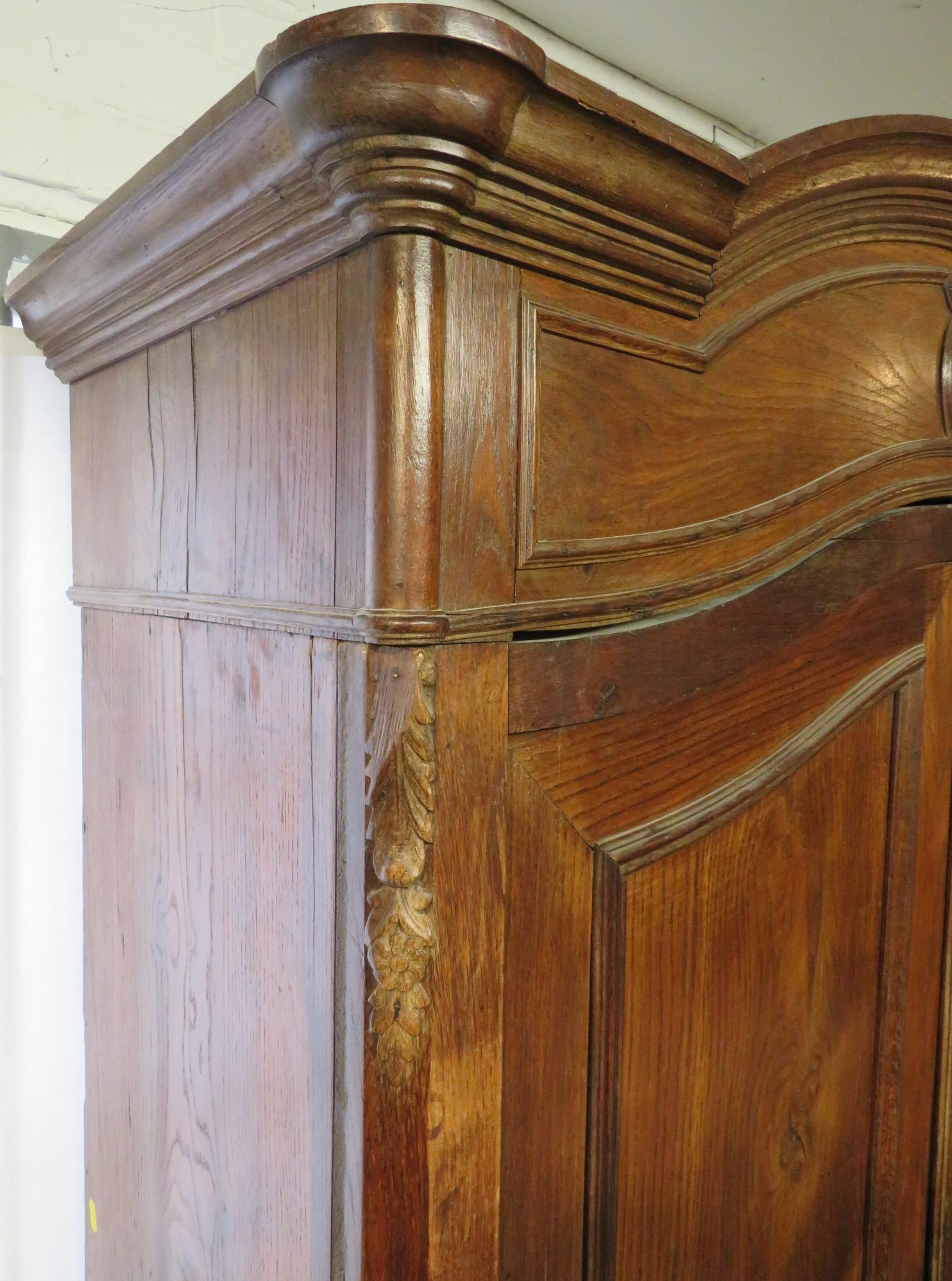 An early 19th century tall French oak armoire, two arch topped doors with long tooled brass - Image 6 of 7