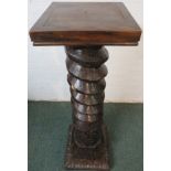 An unusual wooden plant stand, the column made from a substantial wooden cider press screw and